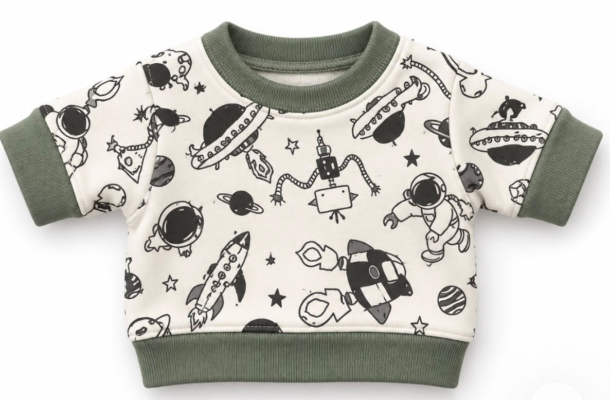 Finished space-print jumper with green ribbed trim, shown as a sewing example